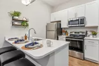 Modern apartment kitchen with stainless steel appliances and high-end finishes