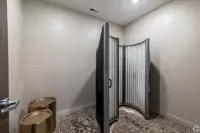 Fully furnished, modern student apartment living room featuring coffee table, mounted TV, and couch
